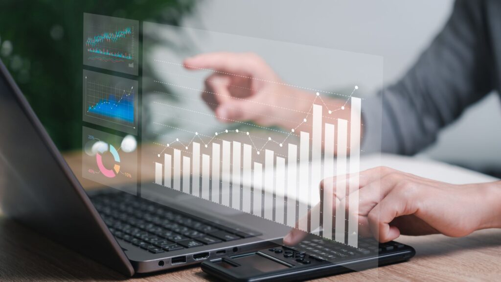 Finger pointing on a laptop and a graph to show the search engine visibility