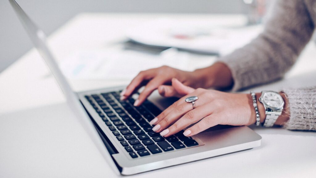 Hands on the keyboard of a laptop