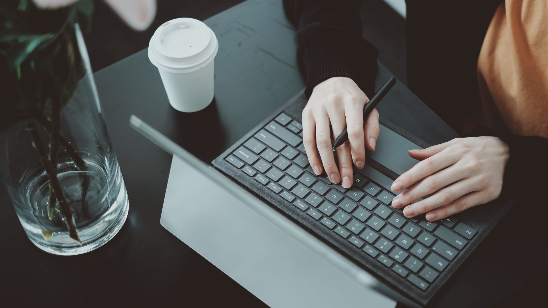 Hands on laptop keyboard practicing 10x content strategy