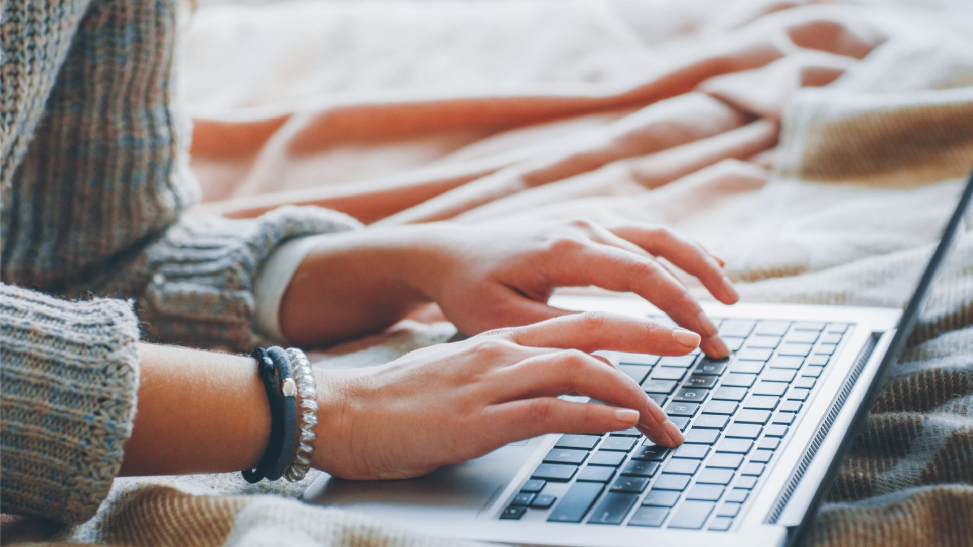 Hands on laptop keyboard practicing content writing