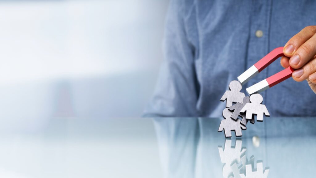 Person holding a magnet symbolizing a lead magnet