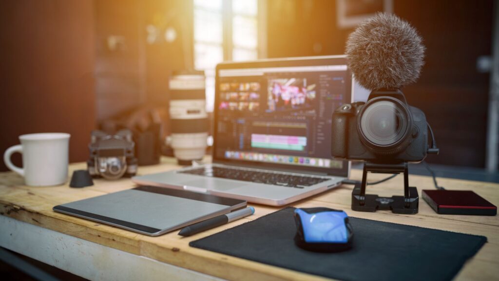 YouTube creator setup with laptop, camera, and microphone.