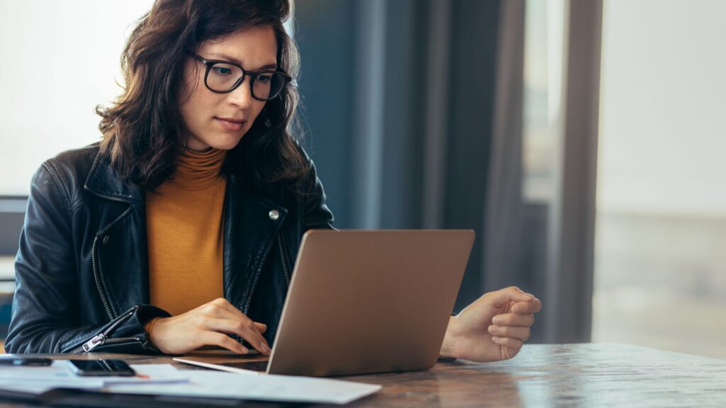 Woman using laptop to distribute content.