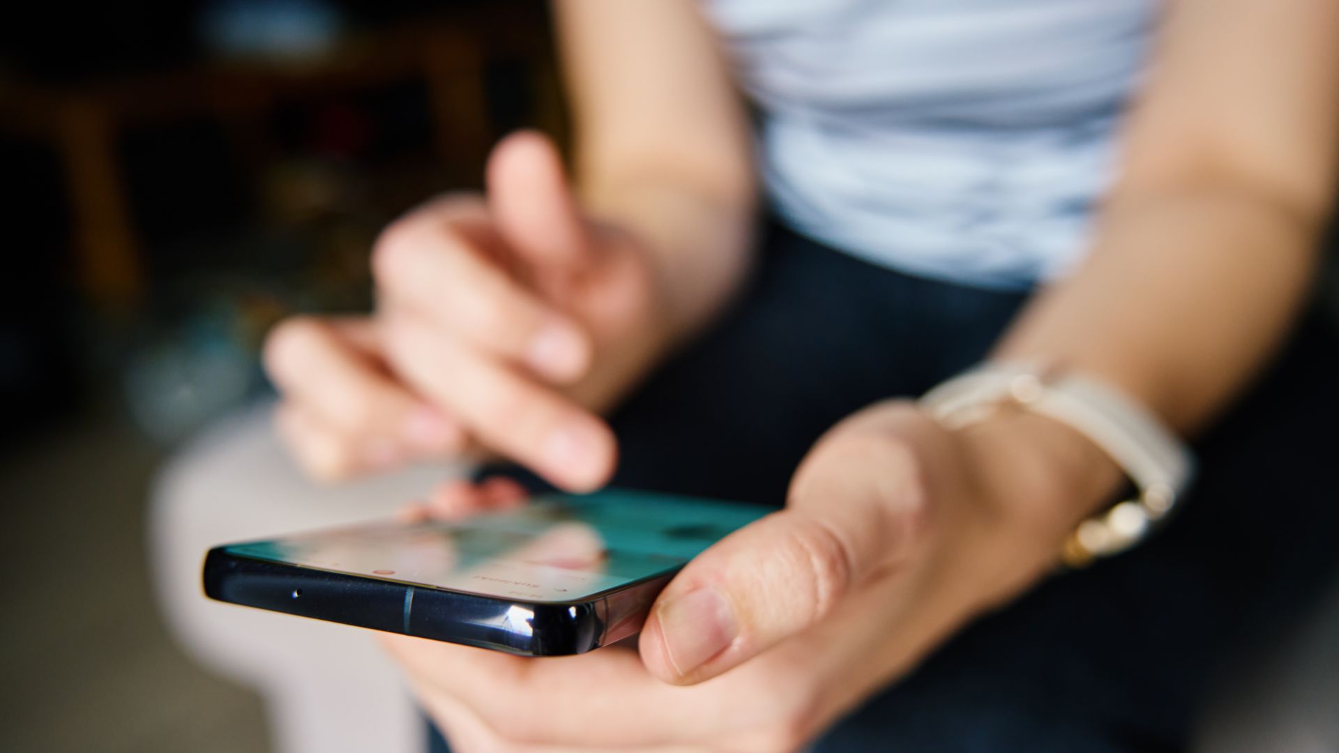 Person holding smartphone using social media.