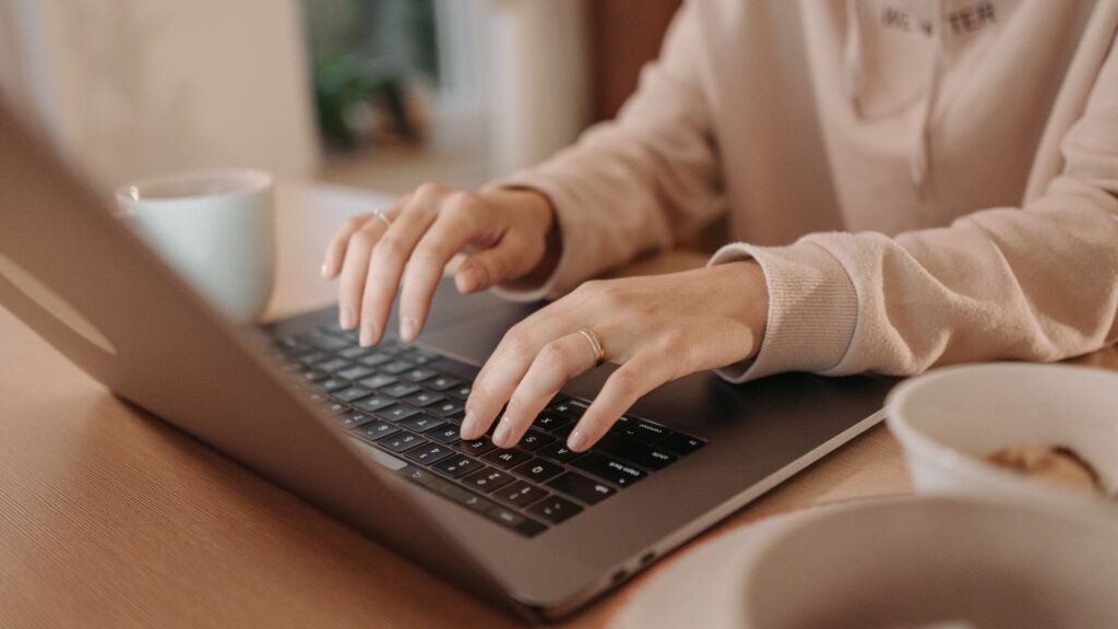 Bing user typing on laptop.