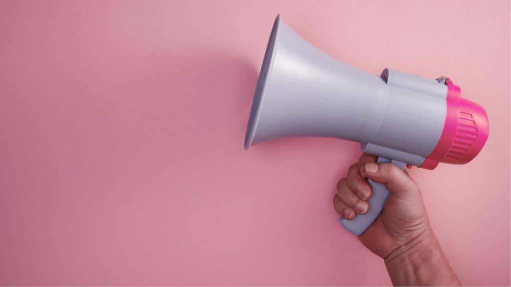 Hand holding a megaphone.