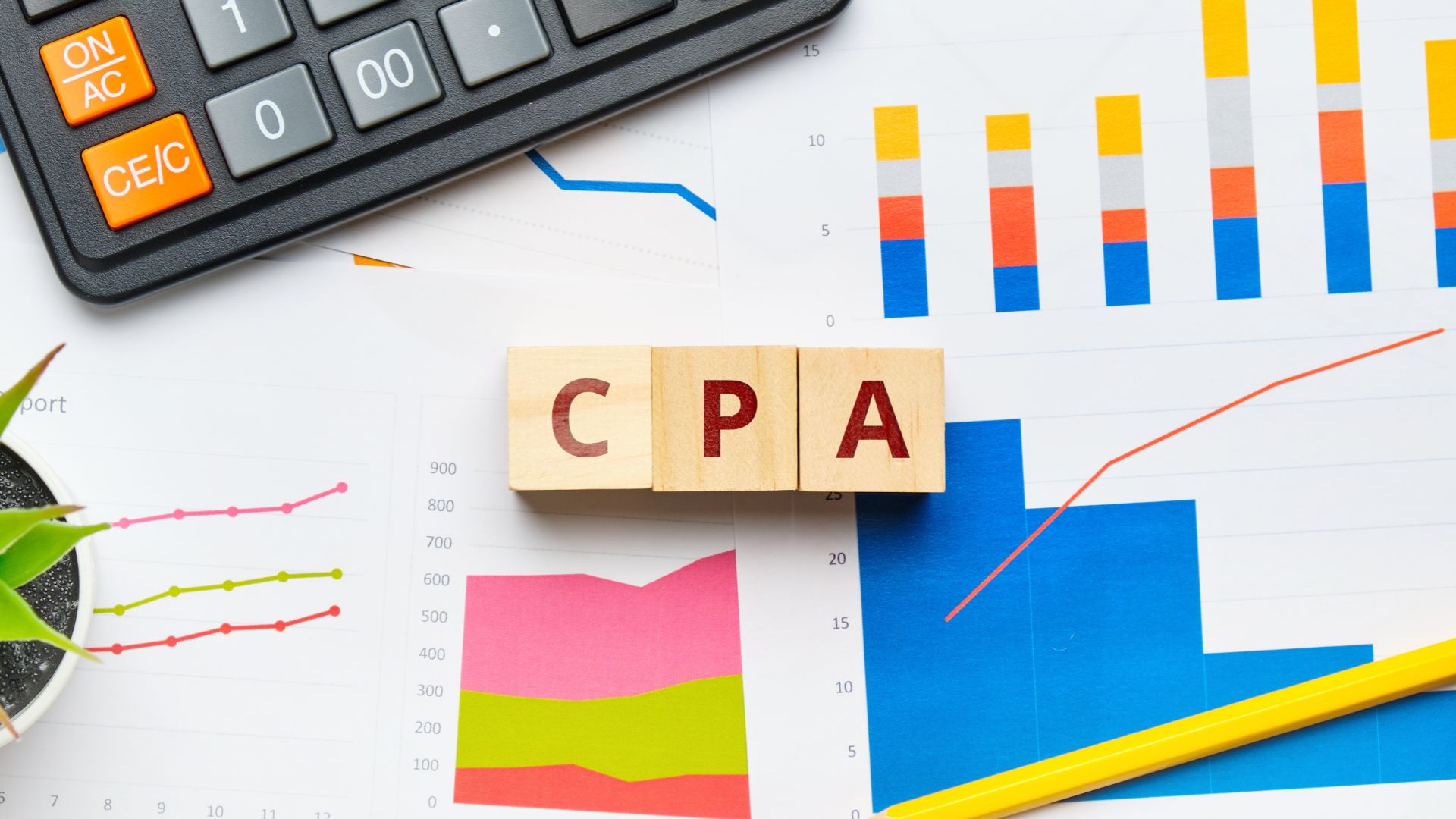 Blocks with letters forming the word "CPA" on a desk.