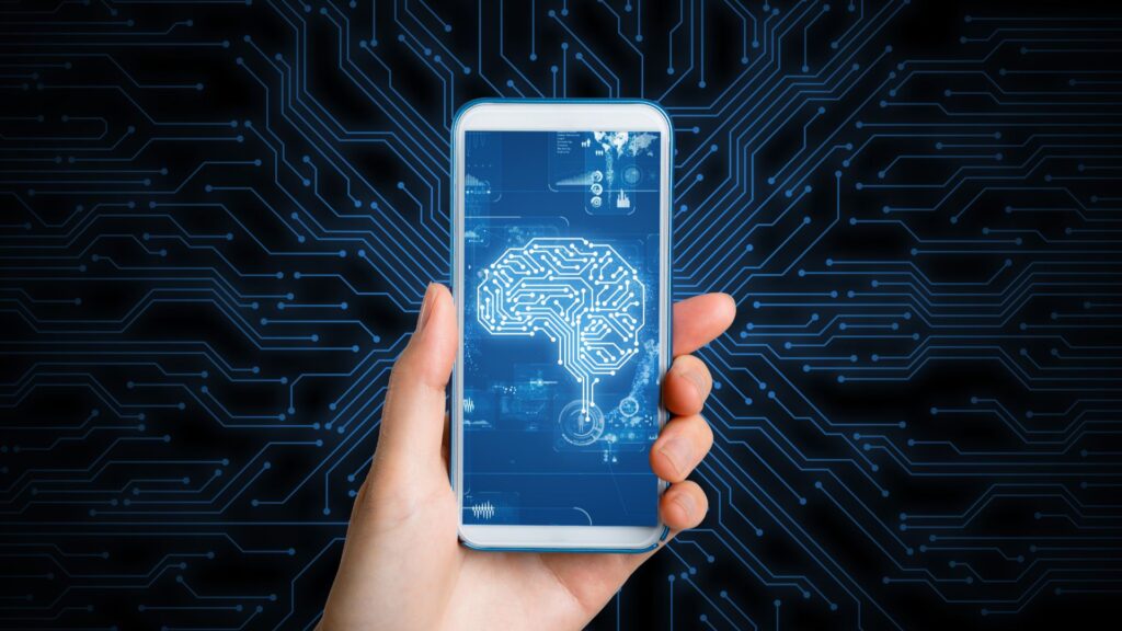 Hand holding a smartphone with a digital image of a brain on the screen.