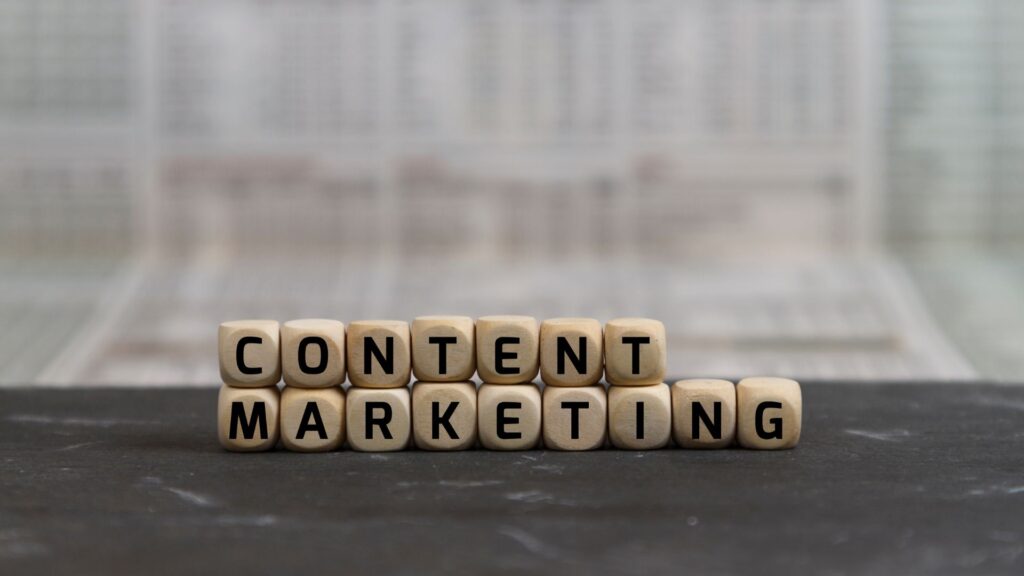 Dices with letters forming the words "content marketing".