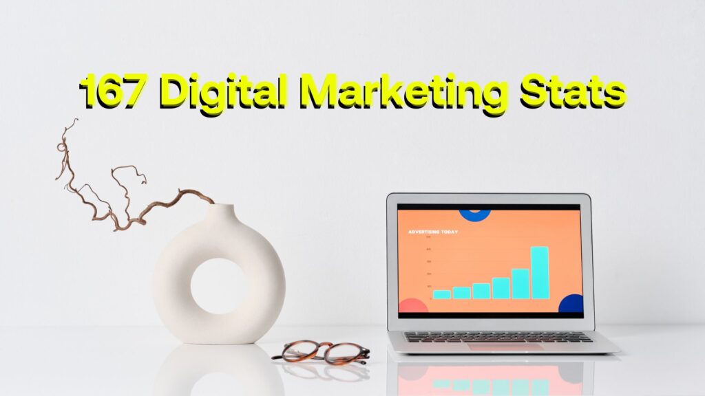 Laptop, a pair of glasses, and a plant with "167 digital marketing stats" written above them.