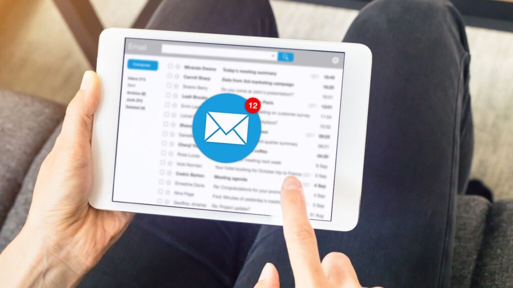 Person holding tablet checking the email inbox