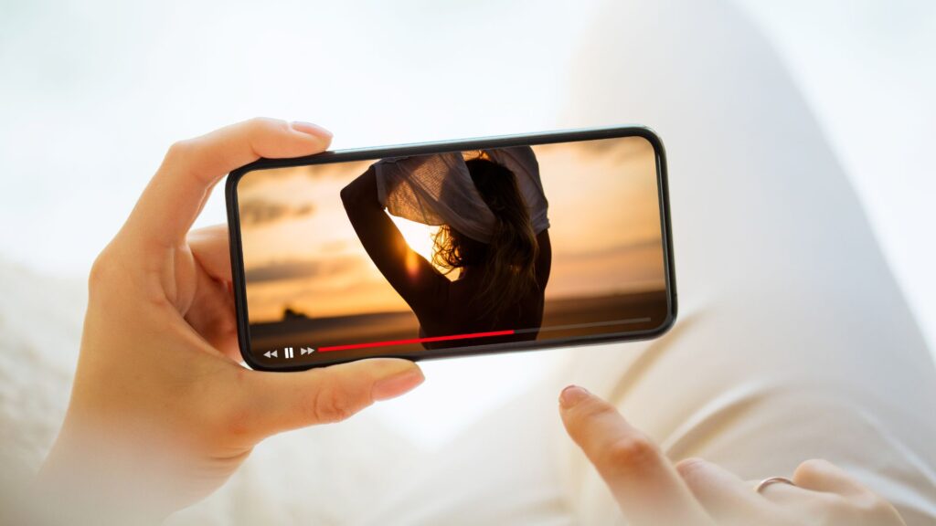 Person watching YouTube video on smartphone.