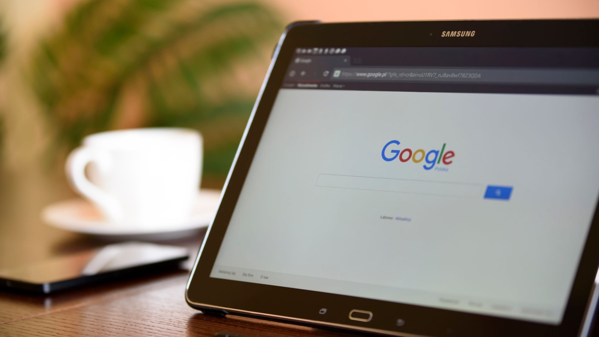 Tablet on desk with Google starting page on the screen.