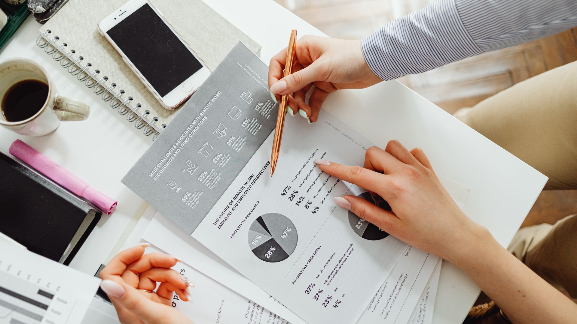 Persons looking at a piece of paper with local SEO statistics on it.