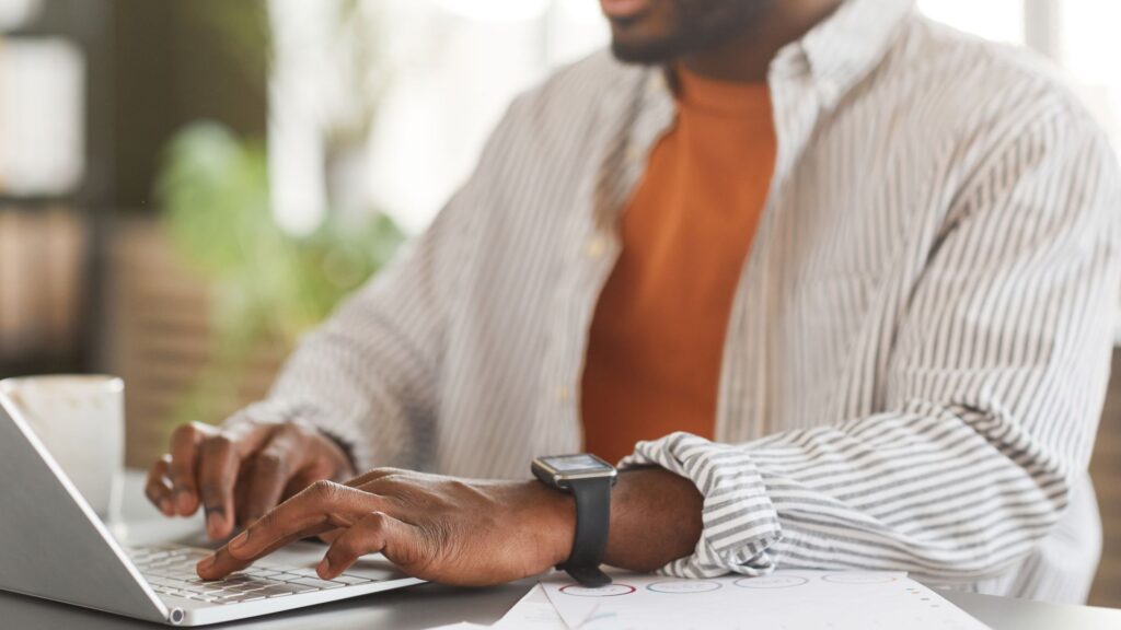 Patreon user typing on laptop.