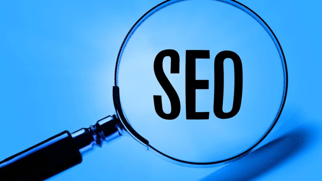 Magnifying glass over the word "SEO" on a blue background.