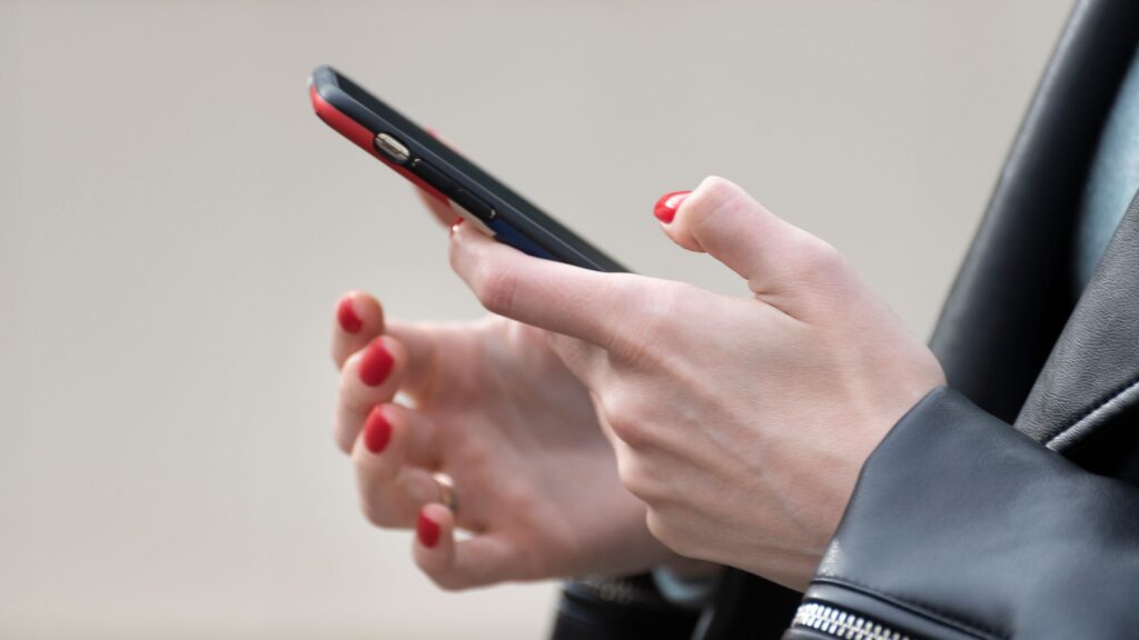 Smartphone user scrolling on smartphone.