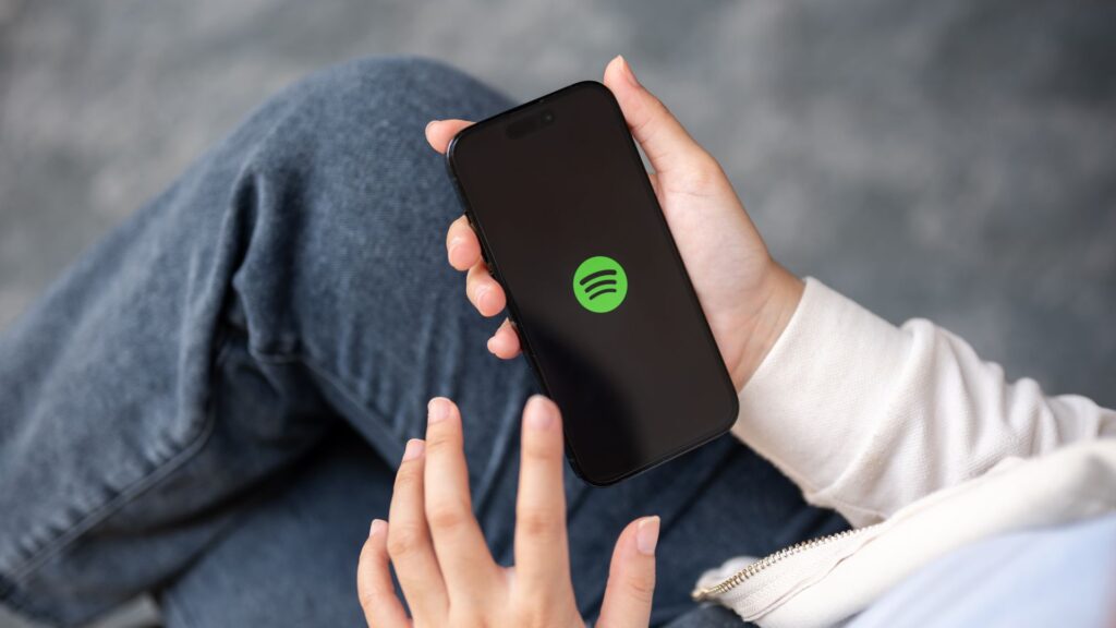 Spotify user opening the Spotify app on a smartphone.