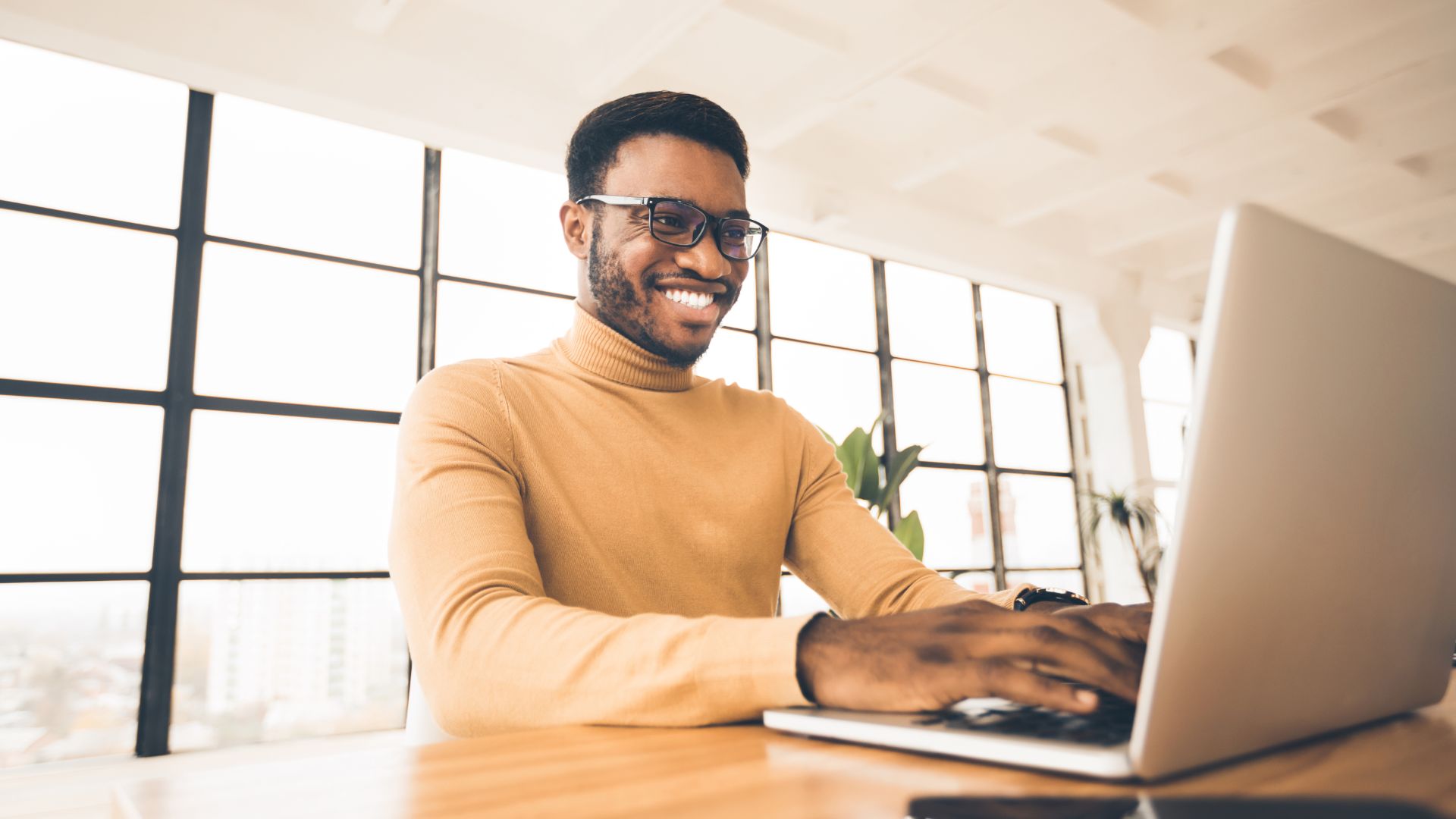 Person sitting by laptop creating a squeeze page