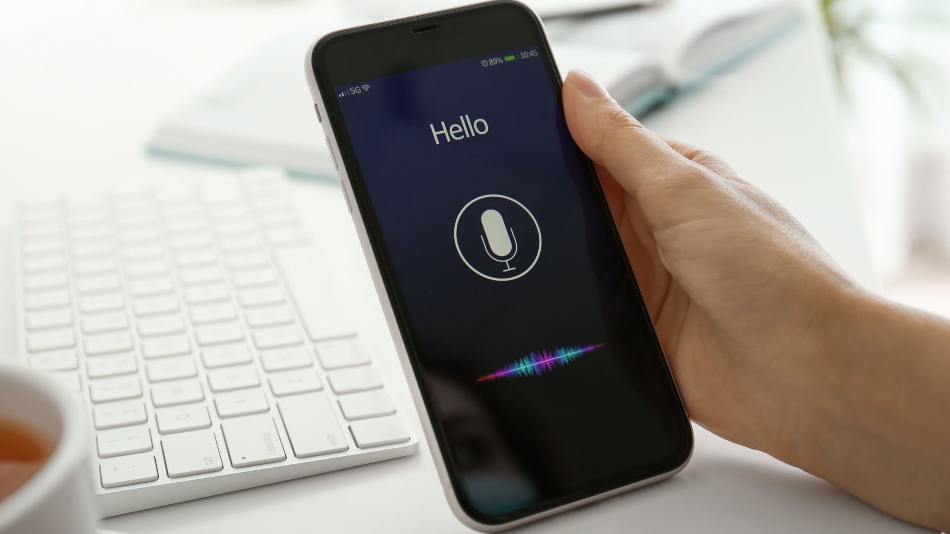 Person holding smartphone to perform a voice search.